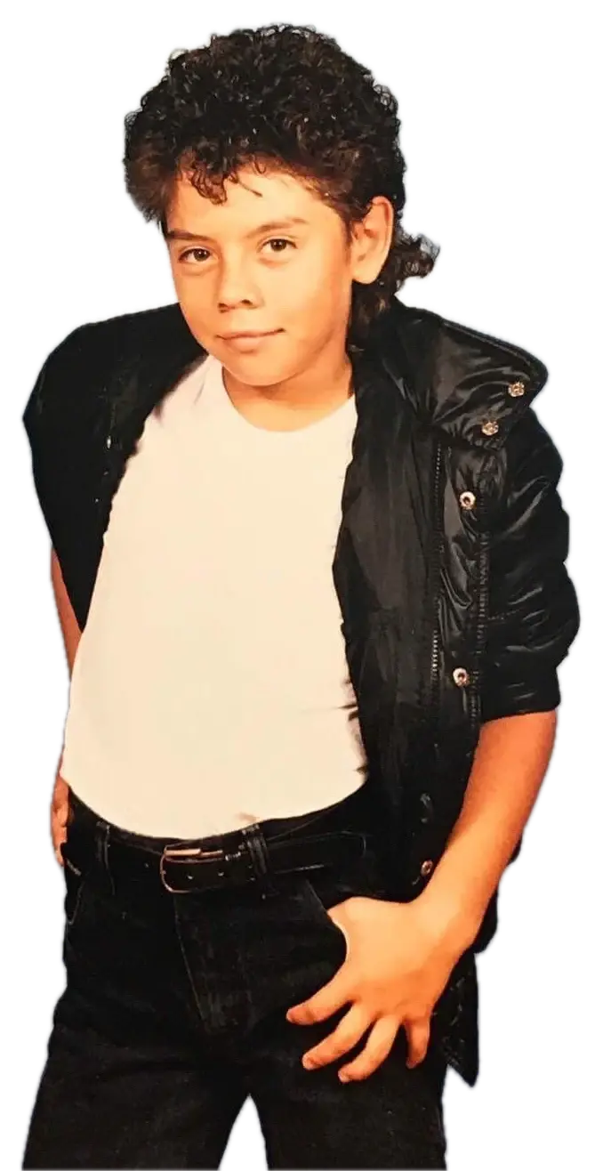 J.J. Villar as a young boy posing in a black jacket and white T-shirt, Michael Jackson style