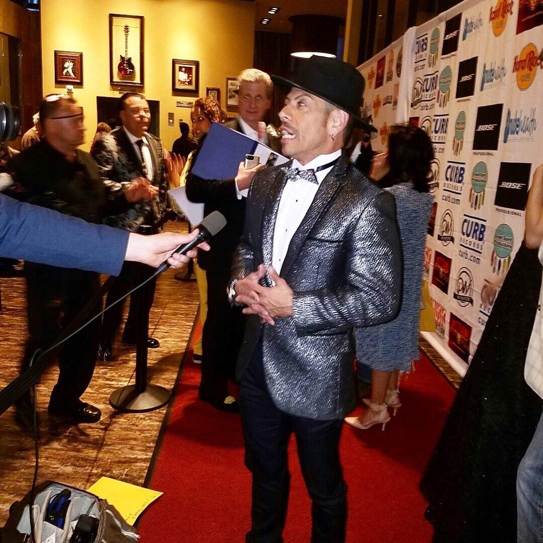 J.J. Villar giving a red-carpet interview at the LA Music Awards