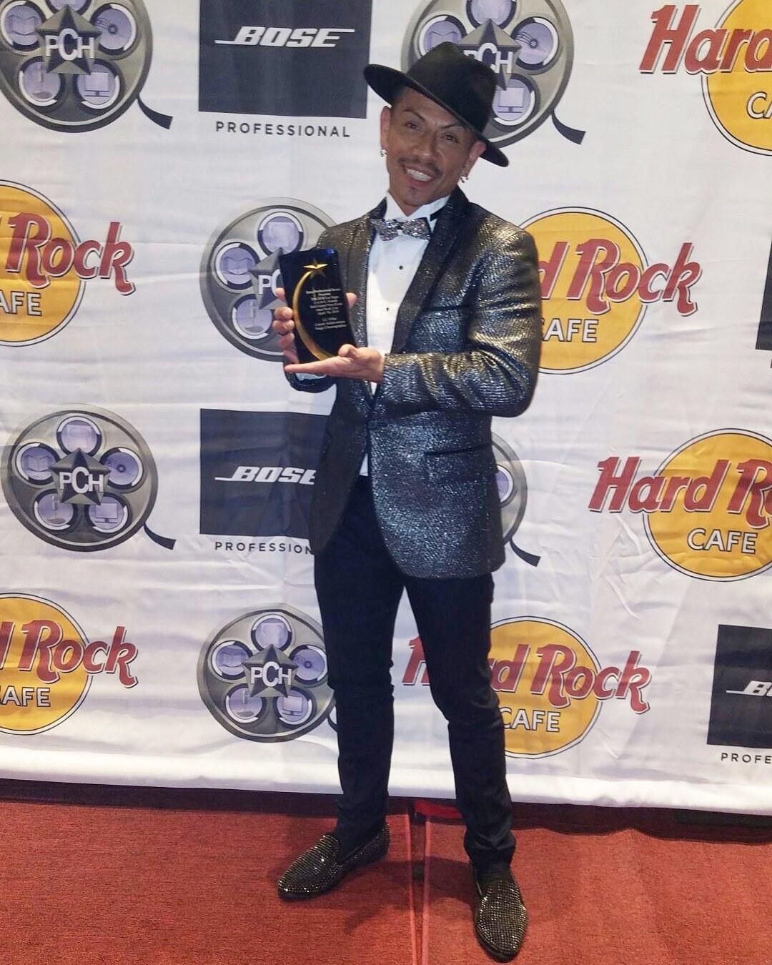 J.J. Villar holding his Lifetime Achievement Award from the LA Music Awards