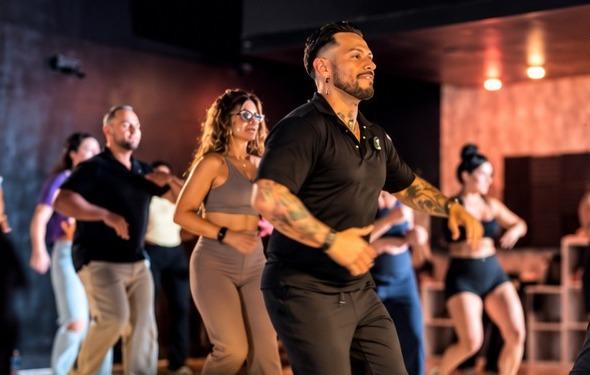 J.J. Villar leading a room full of people through a movement sequence