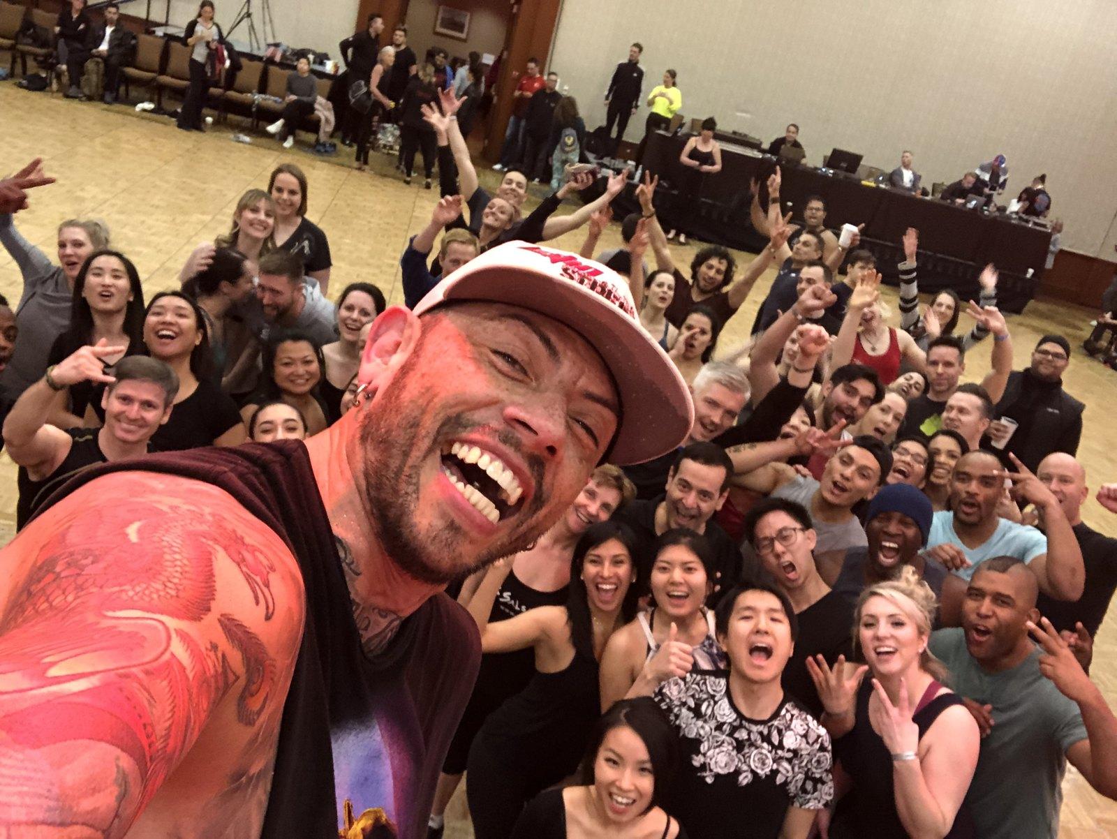 J.J. Villar taking a selfie with a cheering room of workshop dancers